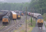 No less than 6 trains are parked in Manchester in the rain waiting for crews